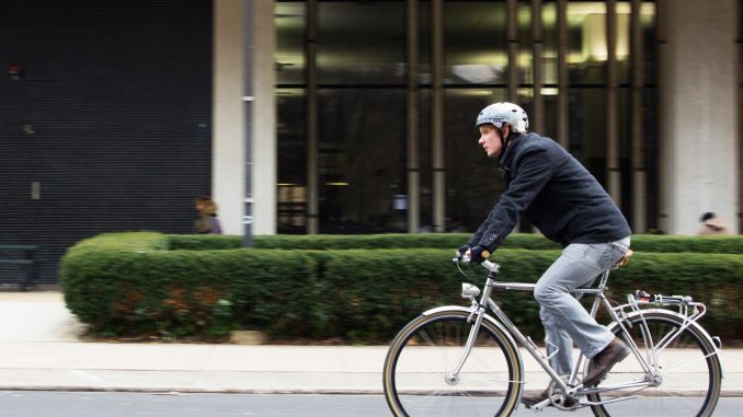 Blake Larson of Bike Temple bikes down 13th Street. | Alex Friend TTN