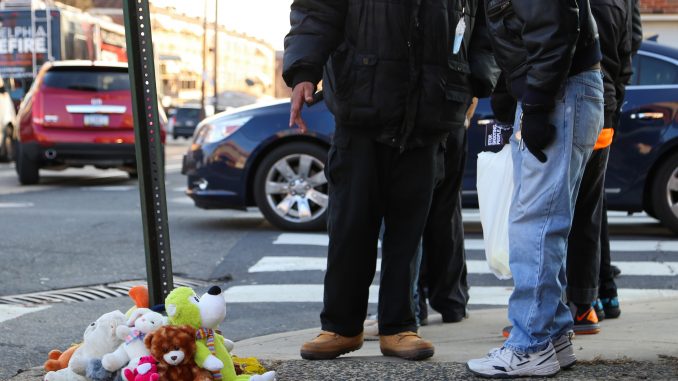 Community members gathered at the corner of 12th and Jefferson streets for a vigil honoring Kim Jones, 56, who was killed at the corner Tuesday morning. | JENNY KERRIGAN TTN