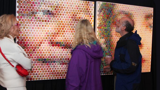 Patrons admire “Mandella and Liz” by Gavin Rain at the E-Moderne Gallerie. | COURTESY E-MODERNE GALLERIE