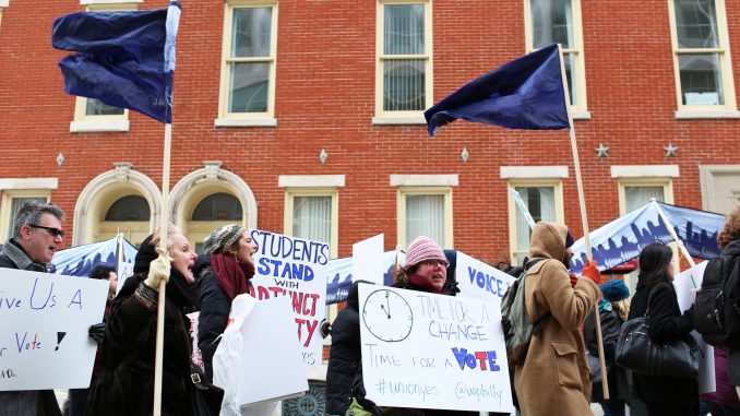 Adjunct professors chant, “Let us vote,” as they march down Liacouras Walk on Feb. 23. Pending a March 19 hearing with the Pennsylvania Labor Relations Board, adjuncts are demanding a vote for or against unionization. | Kara Milstein TTN