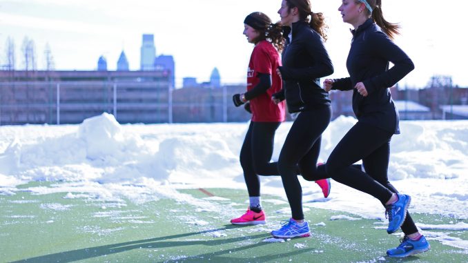 Runners Megan Schneider, (left), Andrea Mathis and Danielle Britton jog at Geasey Field last month. | Jenny Kerrigan TTN