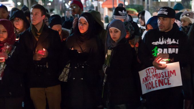 Students gathered at the Bell Tower on Thursday to mourn three Muslim students killed at the University of North Carolina. | Don Otto TTN