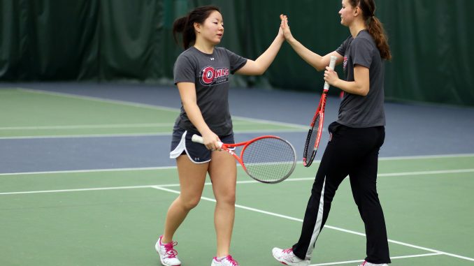 Freshman athlete Yana Khon (left) high-fives teammate Alina Abdurakhimova during practice at the Legacy Center, the Owls’ practice facility. Kara Milstein | TTN