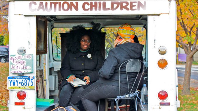 Kaycee Itohan Osadolor conducts an oral history interview inside Erin Bernard’s truck. | COURTESY Jill Saul