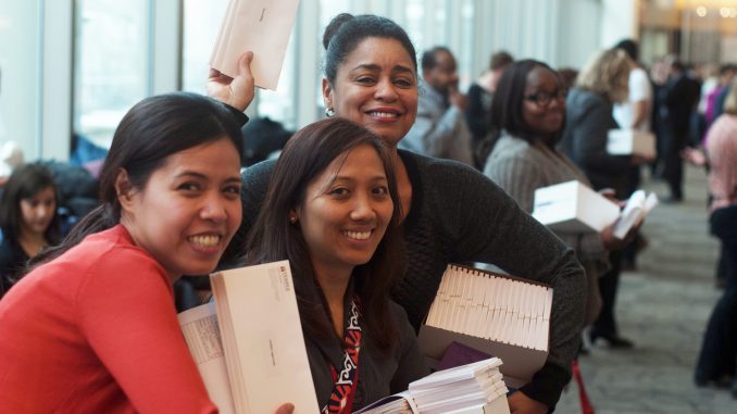 The School of Medicine’s Meg Tanjutco (left), Minette Manalo and Donna Johnson wait to hand out match letters to students. | Allan Barnes TTN