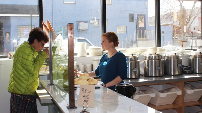 Employee Tara Scott offers a customer a sample of one of Good Spoon’s signature soups. | Eamon Dreisbach TTN