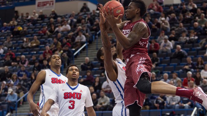 Junior guard Quenton DeCosey (right) fights for possession in Temple’s 69-56 loss to Southern Methodist in the conference semifinals on Saturday. The Owls will take part in the National Invitation Tournament for the first time since the 2005-06 season under former coach John Chaney. That season was Chaney’s last as Temple coach. | Donald Otto TTN