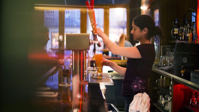 At Earth - Bread + Brewery, Liz Martino, bartender, pours a drink from one of 11 beers on tap that are constantly changing. | Margo Reed TTN