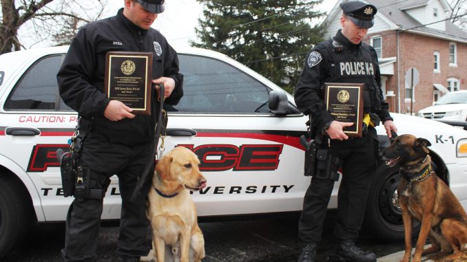 Temple Police Officer Larry Besa (left) stands with his dog Jarvis next to Officer Doug Hotchkiss and his dog Baron. | Claire Sasko TTN