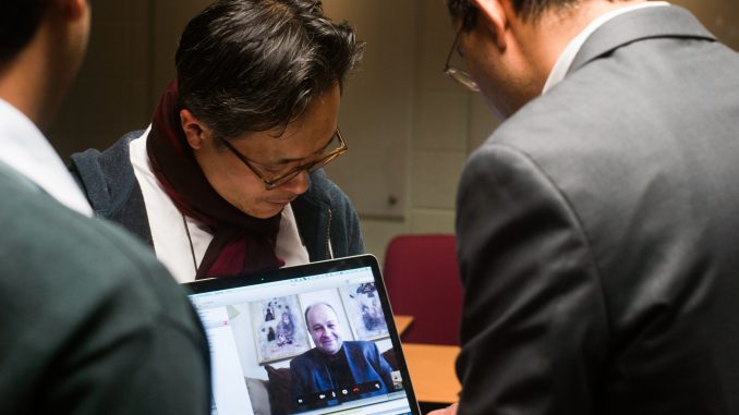 Sunil Wattal and Youngjin Yoo talk to Zoran Obradovic via Skype to discuss research. | Allan Barnes TTN