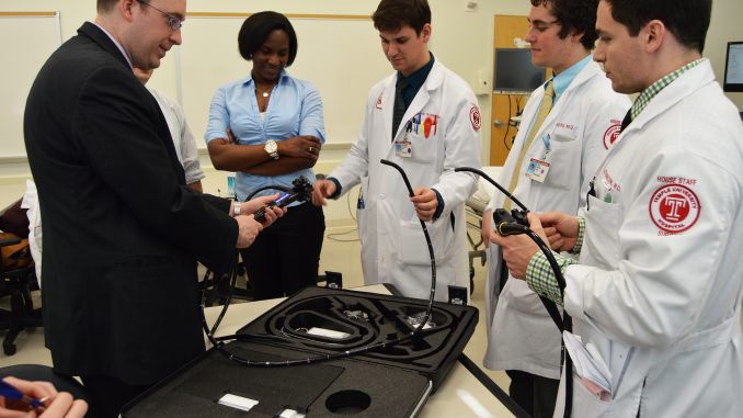 Assistant professor Dr. Matthew Philp teaches a group of residents about a new machine that allows students to simulate upper endoscopy, colonoscopy and bronchoscopy procedures at the Temple Medical School. | Alexa Zizzi TTN