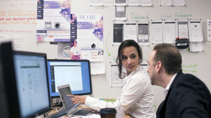 Yasmine Mustafa (left) and Anthony Gold of ROAR work on business plans to discuss at an upcoming meeting. The company hopes to launch by December. | Margo Reed TTN