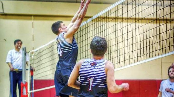 Freshman middle hitter Tyler Phifer attempts a block during a men’s volleyball club match. | COURTESY Zack Hennigan