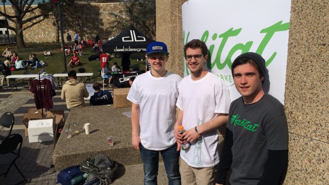 Brandon Bahr (left), Andrew Nekkache and Mike Paszkiewicz – all Habitat developers – stand near the Bell Tower during a day-long student start-up exhibition on April 2. | Alexa Bricker TTN