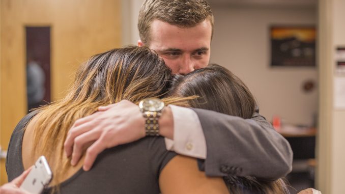 Incoming Student Body President Ryan Rinaldi embraces Brittany Boston and Binh Nguyen, the new vice presidents for services and external affairs, respectively. Their ticket, Future TU, won the Temple Student Government elections with 66 percent of the vote on Thursday. | MARGO REED TTN