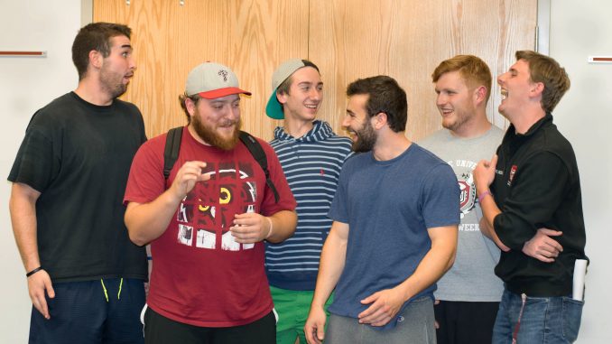 Fraternity members laugh at a recent meeting about the new rushing standards. | Ryan Kuna TTN