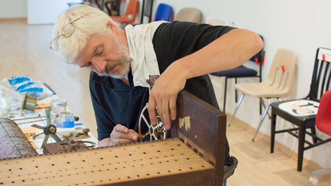 Randy Cleaver, horologist, works on a 19th century flute clock in Temple Contemporary as part of the Restoring Ideals project. | Thomas Joyce TTN