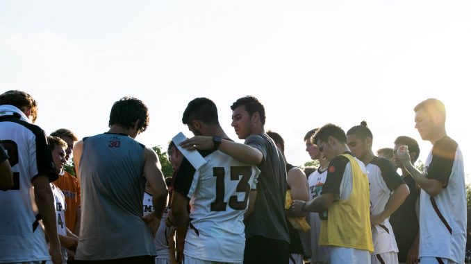 The Owls huddle during their 3-1 victory against Rider Sept. 8. It was the team’s third win of the year. | Brian Tom TTN