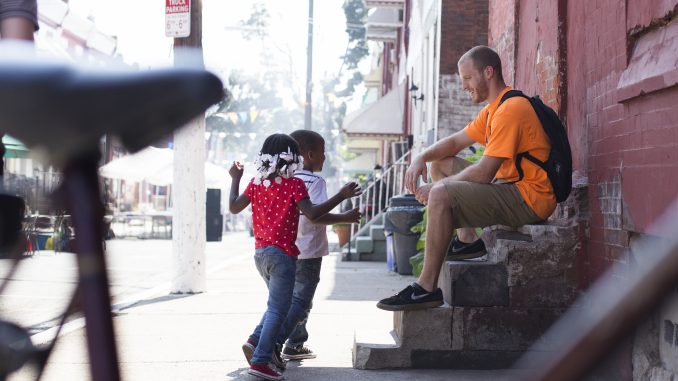 David Suender, founder of the BMX Philly Program, meets children at a block party at 18th and York streets Sept. 7. | Margo Reed TTN