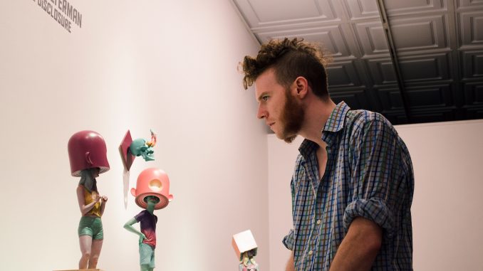 Scott Stitzer views Troy Coulterman’s work at Arch Enemy Gallery in the “Imaginary Menagerie exhibit” last Friday. | Kayleigh Purcell TTN