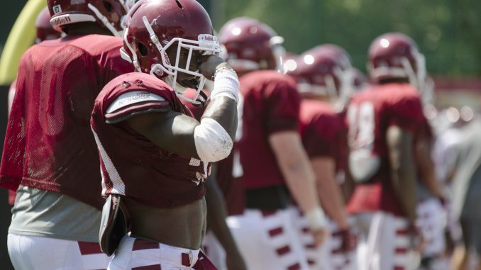 Freshman running back T.J. Simmons wipes away sweat while awaiting conditioning during the Owls’ training camp practice this summer. | Jenny Kerrigan TTN