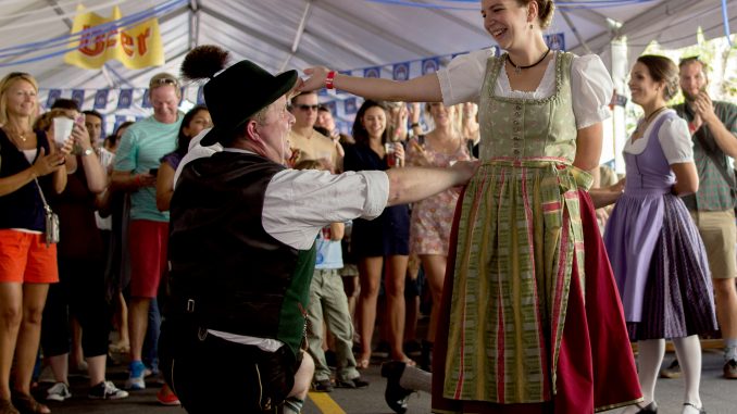 Festival-goers dressed in traditional attire to attend Frankford Hall, showcasing German dancing and music. | Patrick Clark TTN