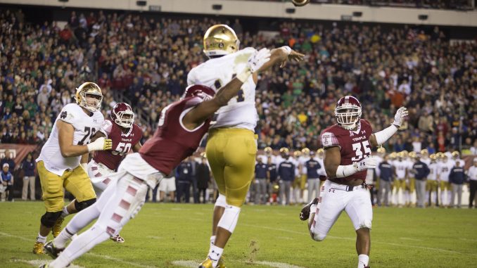 Notre Dame quarterback Deshone Kizer is tackled as he throws the ball Saturday. | Jenny Kerrigan TTN