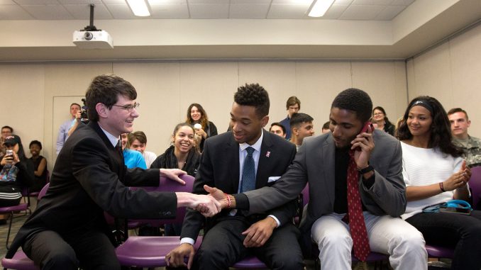 Empower TU presidential candidate Aron Cowen (left) shakes campaign manager Tykee James' hand after learning they had won the 2016-17 TSG election. | DAN RAINVILLE TTN