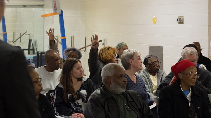 North Philadelphia residents raise their hands during a vote on whether to support or oppose the building of several apartment buildings during a 32nd Democratic Ward meeting at the Amos Recreation Center March 16, 2016. | DANIEL RAINVILLE TTN