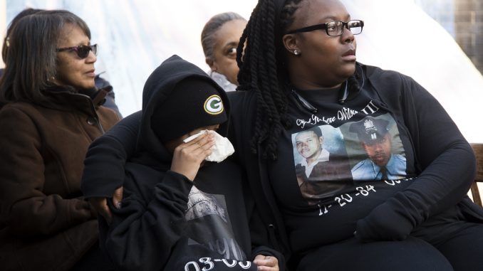 Deja Wolf (right), and her son Quahmier Wolf-Wilson listen to family members speak at Sgt. Robert Wilson III’s vigil on March 5. | Brian Tom TTN